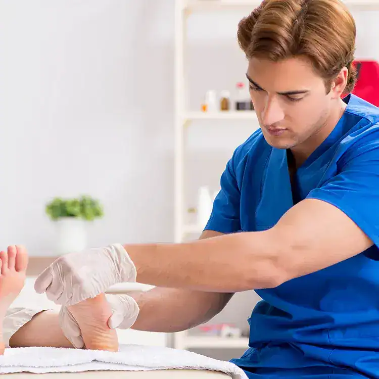 Podiatrist performing foot examination in a clinical setting.