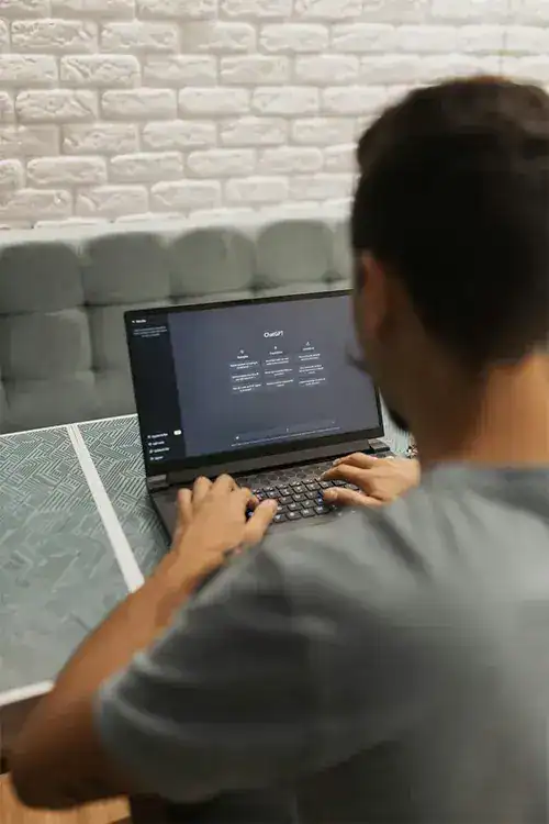 Person working on laptop at practiceedge in a modern office setting.